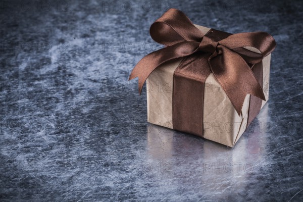 Giftbox on scratched metallic background holidays concept