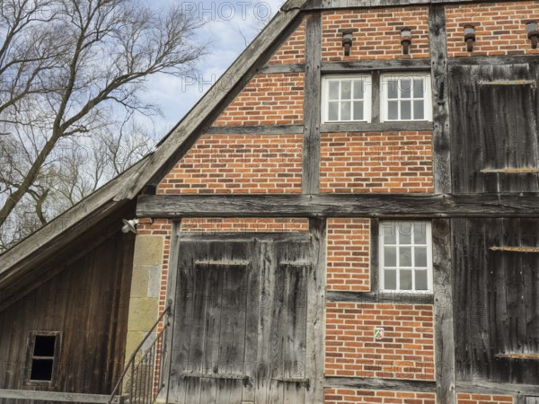 Rustic half-timbered house with striking wooden structure and red bricks, heek, münsterland, germany