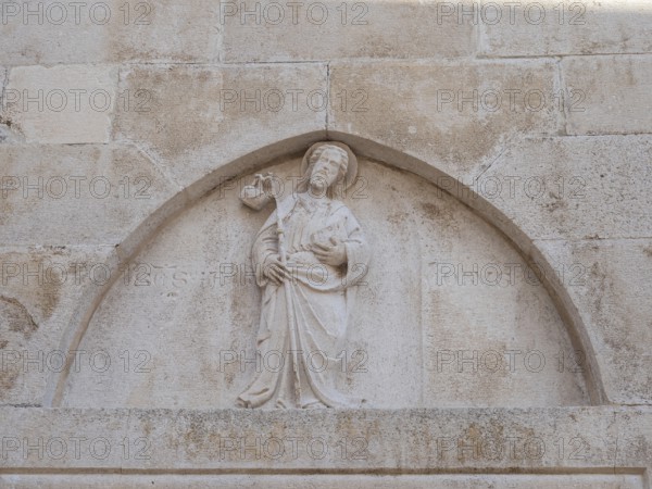 Stone relief on church façade, figure of a saint, old town centre of Korcula, island of Korcula, Dalmatia, Croatia, Europe