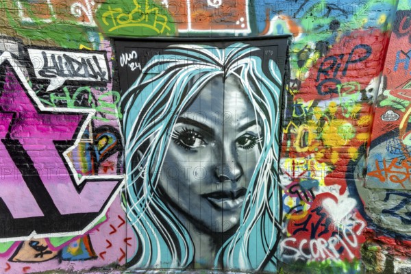 Street art, graffiti of a portrait of a woman by alleyway artists in the graffiti alley in Werregarenstraat, Ghent, East Flanders, Belgium, Europe