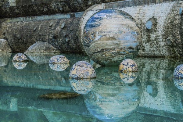 Sejong, South Korea, August 8, 2019: Marble sphere surrounded by smaller spheres in pool of water at Beartree park, Asia