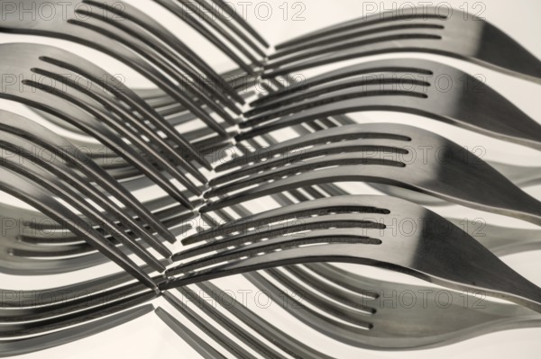 Abstract artistic picture of wavy forks, which form a wave pattern by means of mirroring