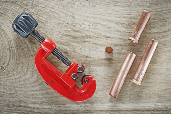 Flared pipes tube cutter on wooden board