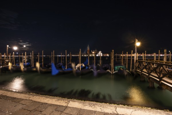 Venetian gondolas, boat dock at St Mark's Square, church of San Giorgio Maggiore in the background, night shot, moon, Venice, Veneto, Italy, Europe