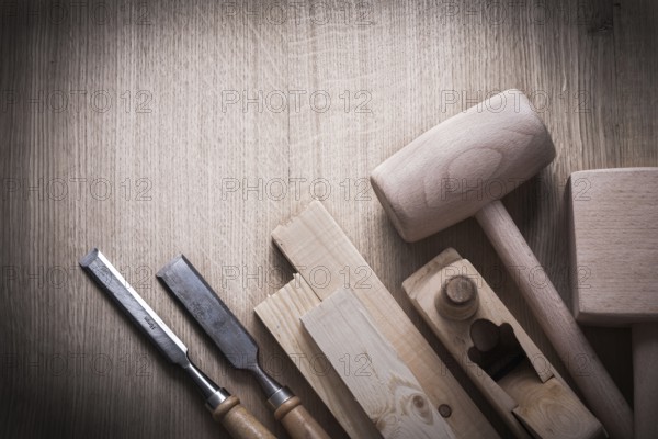 Wooden planks hammers planner flat chisels on wood background construction concept