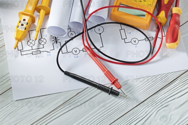 Electric tester and multitester insulated screwdrivers blueprints on white vintage wood