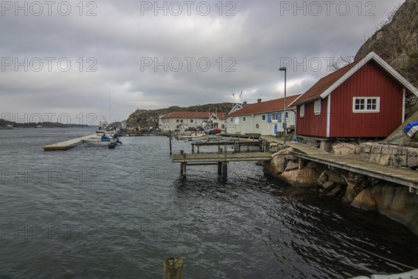 Beautiful village landscape in a fjord. Fishermen and restaurants in the evening at sunset. Boats and a beautiful landscape in Havstenssund, Sweden, Scandinavia, Europe