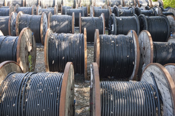 14.06.2017, Berlin, Germany, Europe, Black underground cables for the power supply are wound onto wooden cable reels, Europe