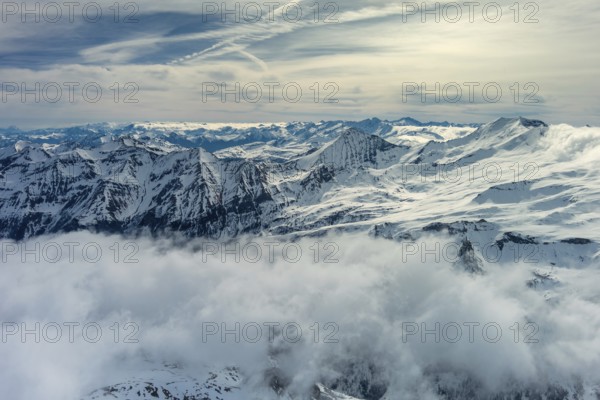 Aerial view of snow mountain range landscape with clouds. Alps mountains, Austria, Europe