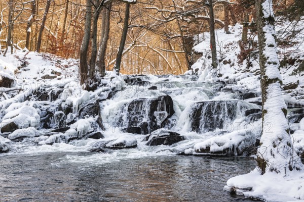Selke waterfall near Alexisbad in the Selke valley Harz in winter with ice and snow