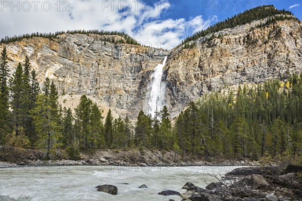 Sunny autumn day in Yoho National Park in the Rocky Mountains of Canada. Colossal Takakkaw waterfall formed by melting glacier Daly