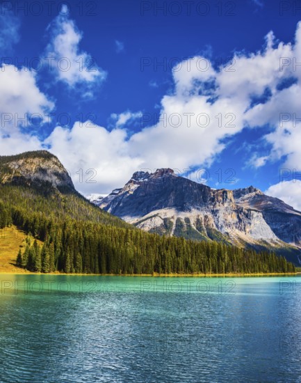 Magic mountain lake Emerald in Canada. The emerald-green lake surrounded by a pine forest