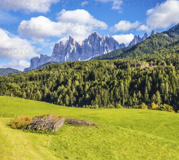 Warm autumn in the Dolomites, the Val de Funes. The valley is surrounded by a dentate wall of dolomite rocks. The concept of ecological tourism