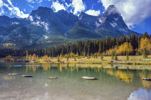 Shining day in Canmore. The famous Three Sisters mountains in the Canadian Rockies. Concept of hiking
