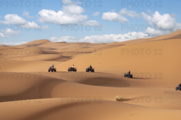 Motorbikers driving off-road in the Erg Chebbi desert near Merzouga, Morocco, Africa