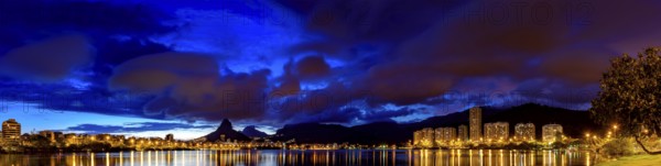 Panoramic image of the first summer night of the year 2018 seen from the lagoon Rodrigo de Freitas with the buildings of the Ipanema and Leblon, Two Brothers hill and Gavea stone on Rio de Janeiro