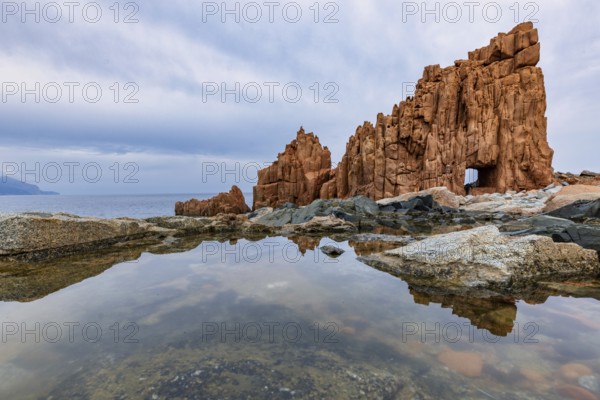 Rocce Rosse, the red rocks of Arbatax are reflected in a tidal pool, Arbatax, Tortoli, Ogliastra, Sardinia, Italy, Europe