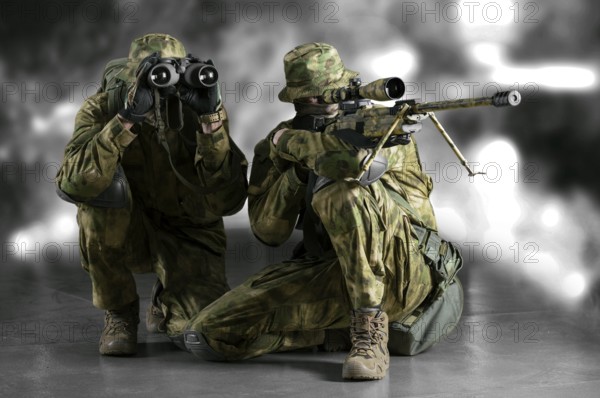Group of snipers with a night vision device tracks the target.