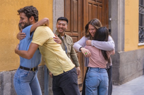 Group of multiracial friends greeting and kissing in the city, friendship concept with boys and girls