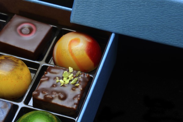 Chocolates in box, black background