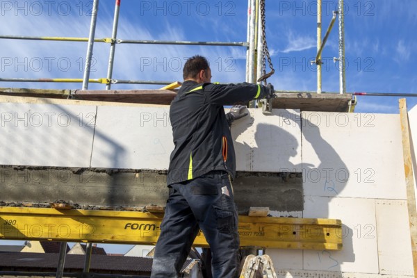 Bricklayer works on a new detached house