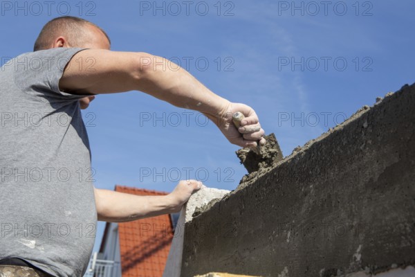 Bricklayer works on a new detached house