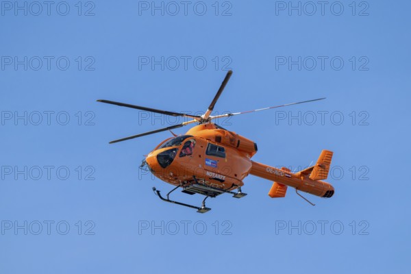 Rescue helicopter, emergency helicopter in flight, Schwaz, Tyrol, Austria, Europe