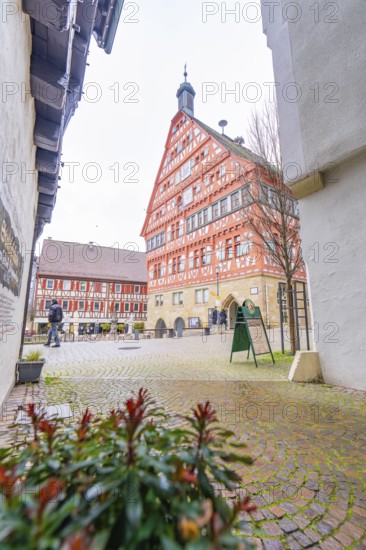 View of a red half-timbered house, town hall, through an alley with cobblestones, Großbottwar, Ludwigsburg district, Baden-Württemberg, Germany, Europe