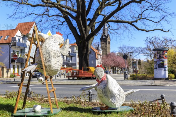 Funny Easter decoration with chickens at Wettinplatz, in the background the New Church Peter and Paul, Coswig, Saxony, Germany, Europe
