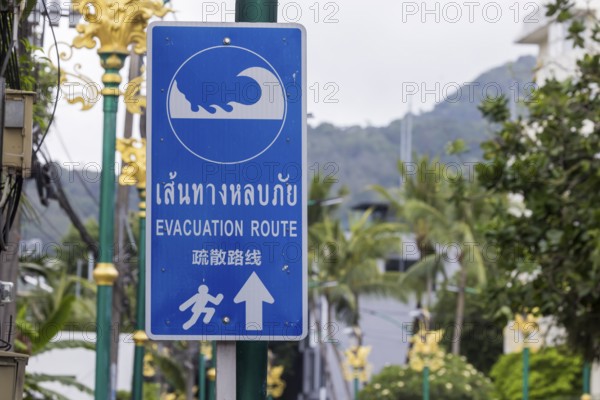 Tsunami Hazard Zone. Warning sign, signposting of escape routes in the event of another seaquake. Beach area and coastal road in the town of Patong, Kathu, Phuket Island, Thailand, Asia
