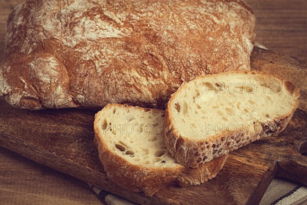 Sliced ciabatta, on a chopping board, italian bread, close-up, Italian cuisine, breakfast, no people