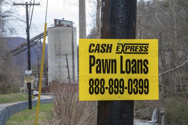 Lynch, Kentucky - A pawn shop advertises near coal mining equipment that remains in a former U.S. Steel company town in Harlan County. Automation and the subsequent closure of most mines have reduced the area's population and increased its poverty