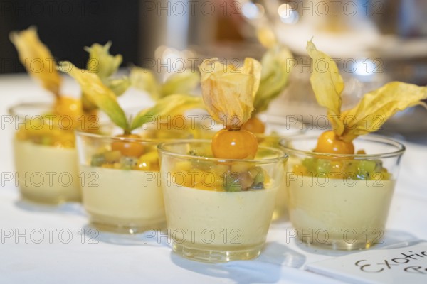 Small glasses with an exotic dessert of mango, kiwi and physalis on a white tablecloth, Europäischer Hof, Königsbach Stein, Germany, Europe