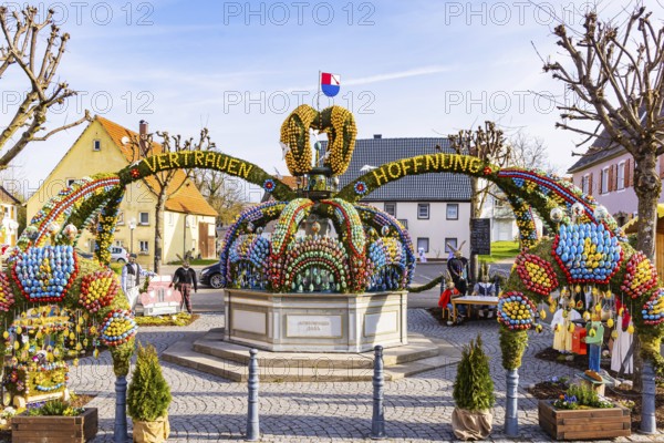 The Easter fountain in Schechingen has around 13, 000 hand-painted eggs. This makes it one of the largest and most beautiful in the whole of East Württemberg. Around 50, 000 visitors admire the decorated village fountain every year. Schechingen, Ostalbkreis, Baden-Württemberg, Germany, Europe