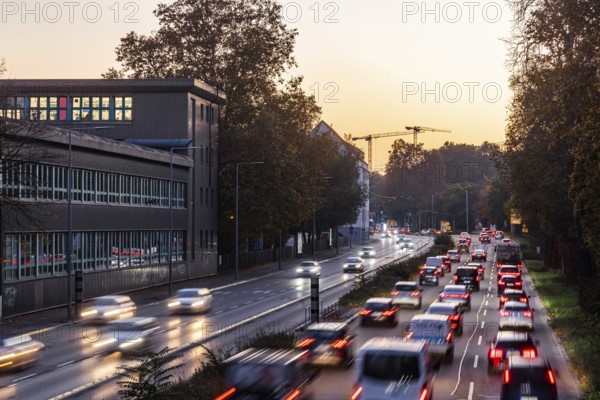 City centre street with heavy traffic in the evening. Dynamic light trails with long exposure time. Sunset. Six-lane federal road at the Neckartor in Stuttgart, Baden-Württemberg, Germany, Europe
