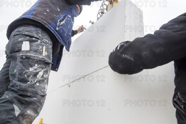 Bricklayers work on a new detached house