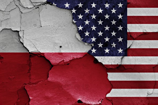 Flags of Poland and USA painted on cracked wall