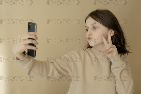 Girl, 10, takes a selfie with mobile phone