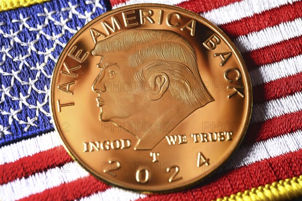 Election campaign coin with portrait of Donald Trump on USA flag, symbolic photo US presidential election campaign
