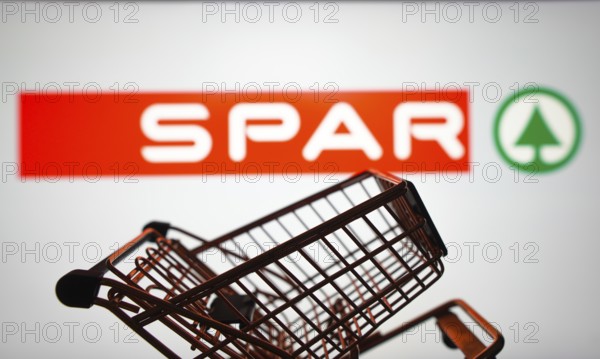 March 31, 2024, Brazil. In this photo illustration, the SPAR logo seen displayed on a smartphone along with a shopping cart