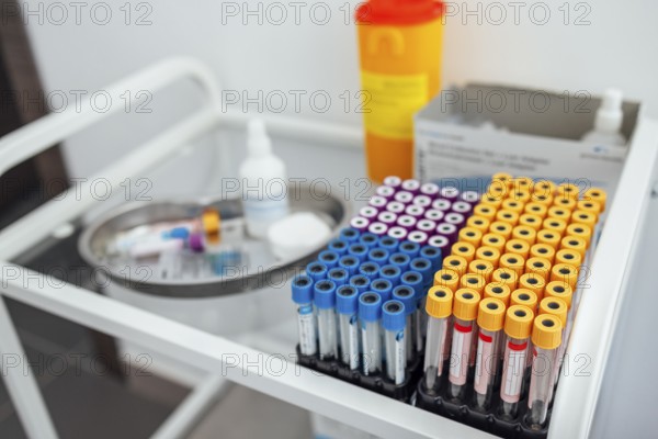 Blood test tubes on the glass table in clinic. Close up