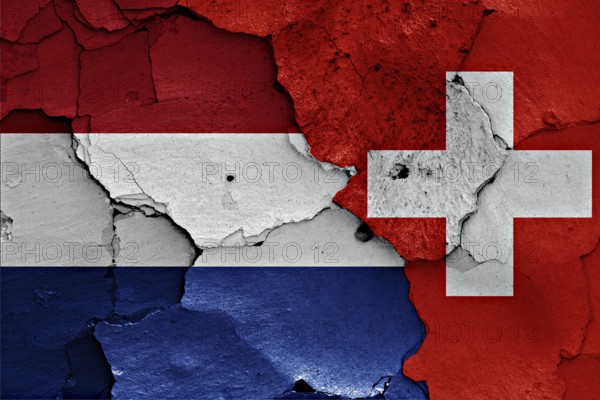 Flags of Netherlands and Switzerland painted on cracked wall