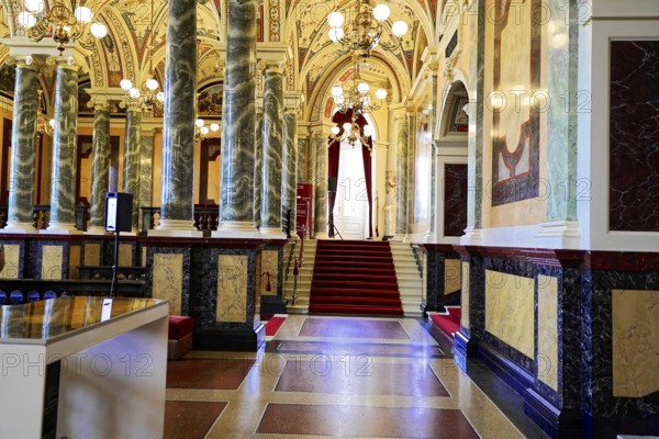 Interior design, Semperoper, Dresden, Saxony, Germany, Europe, An elegant hallway with marble columns, chandeliers and a staircase in a historic building, Europe