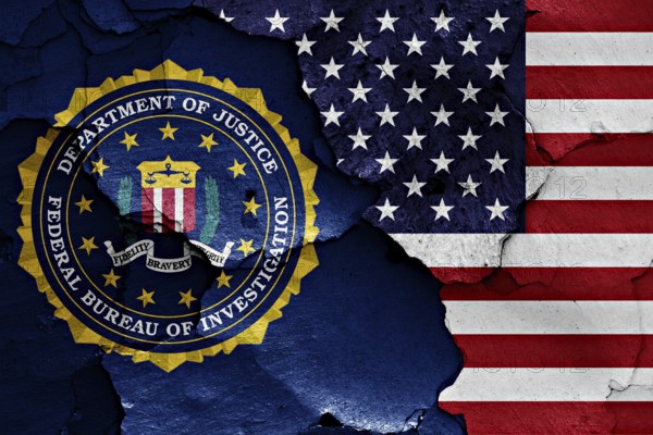 Flag of FBI and USA painted on cracked wall