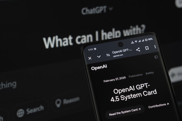 A smartphone screen featuring the introduction of GPT-4.5, with the ChatGPT website visible on a computer screen in the background