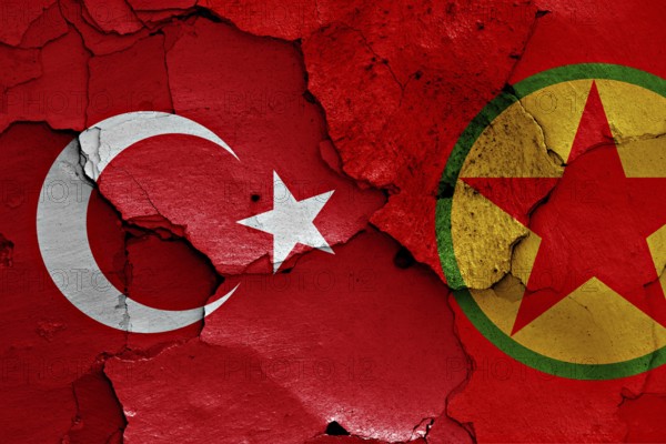 Flags of Turkey and PKK painted on cracked wall