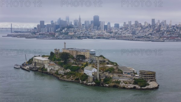 Aerial view of United States Penitentiary, Alcatraz Island, shows a historic maximum-security prison on a small island off San Francisco. Built in 1910-12, it operated from 1934 to 1963 and is now a major tourist attraction