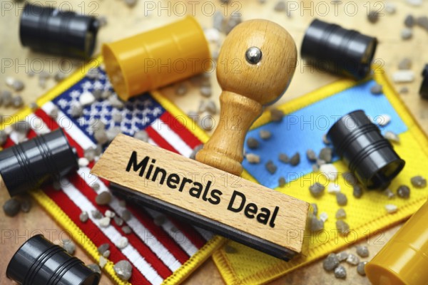 Stamp with inscription Minerals Deal on the flags of the USA and Ukraine with barrels and stones, symbolic photo raw materials deal between the USA and Ukraine, photomontage