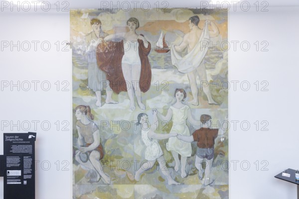 The partial uncovering of the early work in the Deutsches Hygiene-Museum has been completed In the south stairwell foyer of the Deutsches Hygiene-Museum, the large-format mural Lebensfreude (Joy of Life) was created in 1956, with which the then 24-year-old Gerhard Richter completed his studies at the Dresden Academy of Fine Arts. This diploma work, measuring around 63 square metres, was painted over in 1979 and then largely forgotten. After two smaller windows had already been opened in the 1990s, a central section of this historically significant work of art has been uncovered since February 2024 with Gerhard Richter's consent. The result of this complex restoration project can now be viewed. The uncovering was a joint project of the Deutsches Hygiene Museum and the Wüstenrot Foundation in co-operation with the Dresden University of Fine Arts. The accompanying educational measures were supported by the Ernst von Siemens Art Foundation through a