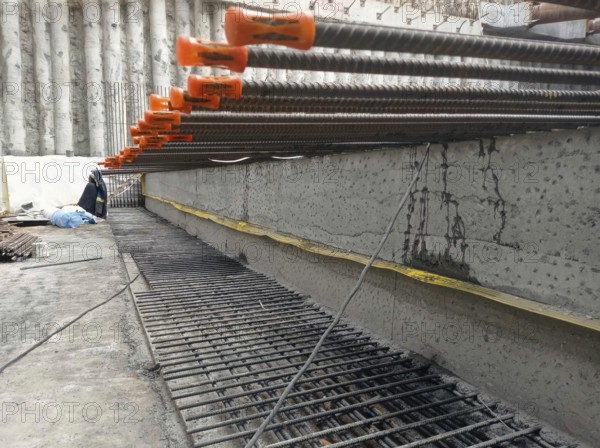 Close-up of reinforcement bars and concrete at a construction site